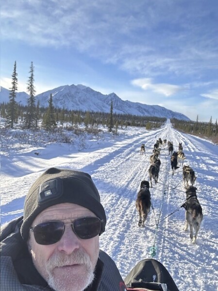 In this undated photo provided by Jeff King, the four-time Iditarod Trail Sled Dog Race winner takes a selfie with his dog team as they approach Mount McKinley, formerly known as Denali, near Denali National Park and Preserve, Alaska. (Jeff King via AP)