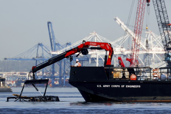 The U.S. Army Corps of Engineers debris removal vessel The Reynolds works near the collapsed Francis Scott Key Bridge, Monday, April 15, 2024, in Baltimore. The FBI confirmed that agents were aboard the Dali conducting court-authorized law enforcement activity. (AP Photo/Julia Nikhinson)