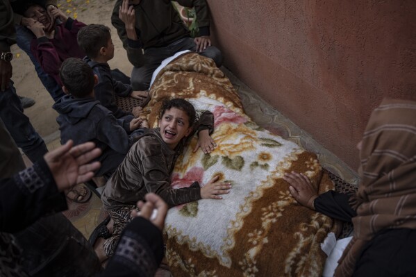Palestinians mourn their relatives killed in the Israeli bombardment of the Gaza Strip, in the hospital in Khan Younis, Saturday, Nov. 11, 2023. ( AP Photo/Fatima Shbair)