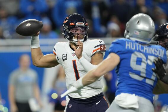 Chicago Bears quarterback Justin Fields (1) throws during the second half of an NFL football game against the Detroit Lions, Sunday, Jan. 1, 2023, in Detroit. (AP Photo/Paul Sancya)