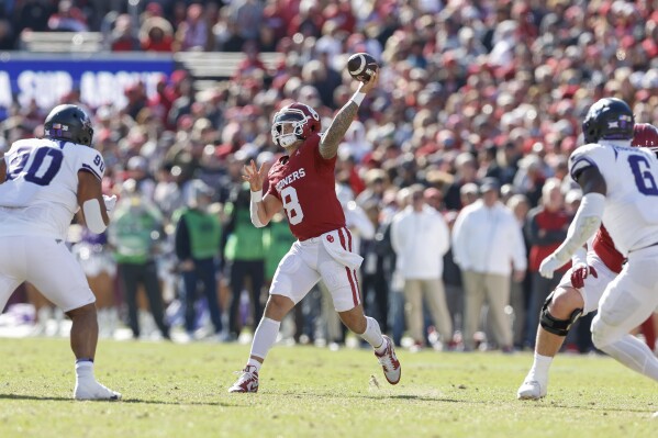 Oklahoma quarterback Dillon Gabriel (8) passes against TCU during the first half of an NCAA college football game Friday, Nov. 24, 2023, in Norman, Okla. (AP Photo/Alonzo Adams)