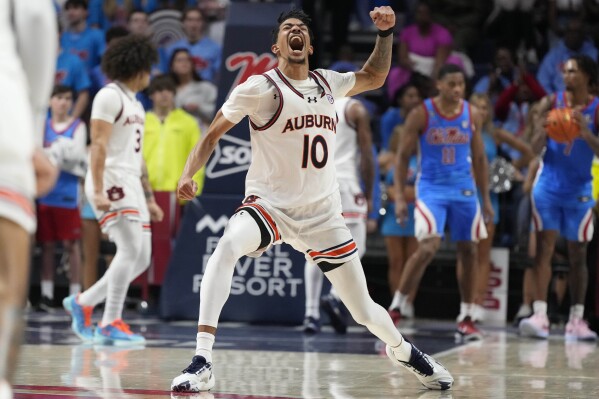 Auburn guard Chad Baker-Mazara (10) celebrates after his team pulled ahead of Mississippi during the second half of an NCAA college basketball game, Saturday, Feb. 3, 2024, in Oxford, Miss. (AP Photo/Rogelio V. Solis)