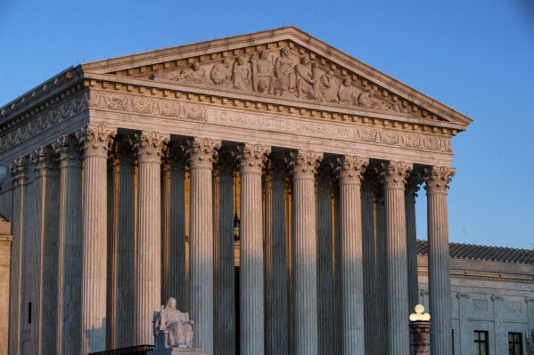 FILE - The U.S. Supreme Court is seen at sunset, March 27, 2019, in Washington. The Supreme Court has a lot of work left to do, and little time to do it. The court is headed into its final few weeks with nearly half of the cases heard this year undecided, including ones that could reshape the law on everything from guns to abortion to social media. (AP Photo/Alex Brandon)