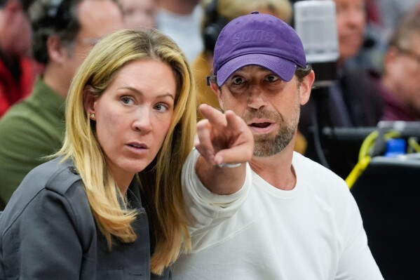 Justin Ishbia, right, brother of Phoenix Suns owner Mat Ishbia, and his wife Kristen Ishbia, left, sit courtside during the first half of an NBA basketball game against the Chicago Bulls, Saturday, Feb. 22, 2025, in Chicago. (AP Photo/Erin Hooley, File)