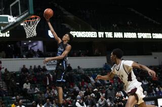 FILE - In this Dec. 9, 2019, file photo, Ypsilanti Lincoln's Emoni Bates shoots against River Rouge during the Tip Off Classic high school basketball game in Ypsilanti, Mich. Bates has committed to Memphis, adding another five-star recruit to coach Penny Hardaway's roster. Bates announced his decision Wednesday, Aug. 25, on Instagram after narrowing his choices to Michigan State, Oregon and the NBA's G League. The Michigan native committed to Tom Izzo and the Spartans last year before changing his mind in April. (Nicole Hester/Ann Arbor News via AP)