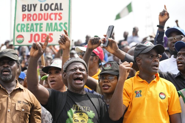 Labour unionist march on the streets to protest economic hardship in Lagos Nigeria, Tuesday, Feb. 27, 2024. Nigerian government workers began a new nationwide strike Tuesday, that threatens to shut down key services across the country. Protestors are angry at the growing economic hardship with talks late Monday night breaking down to avert the walkout. (AP Photo/Sunday Alamba)