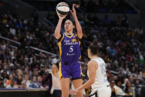 Los Angeles Sparks forward Dearica Hamby (5) shoots against Las Vegas Aces guard Kelsey Plum during the second half of a WNBA basketball game, Sunday, June 9, 2024, in Los Angeles. (AP Photo/Ryan Sun)