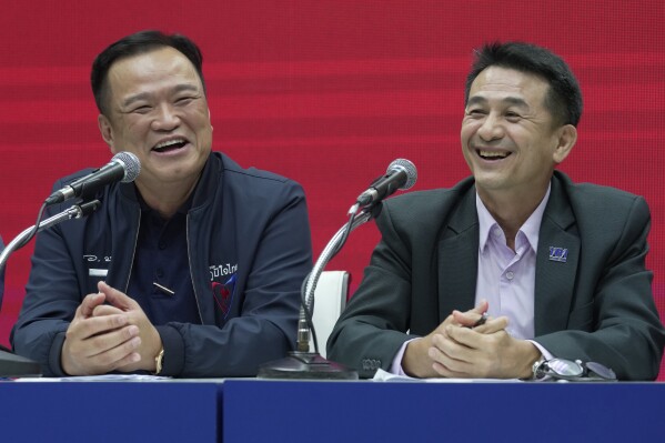 Leader of Bhumjaithai Party Anutin Charnvirakul, left and Leader of Pheu Thai party Chonlanan Srikaew smile during a press conference announcing coalition party at Thai Party headquarters in Bangkok, Thailand, Monday, Aug. 7, 2023. The populist Pheu Thai Party on Monday announced it will assemble a coalition with the Bhumjaithai Party from the outgoing administration to solve the months long political deadlock. (AP Photo/Sakchai Lalit)