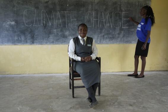 Elizabeth Motale, right, a climate agriculture expert, prepares for a climate change lesson at Chileshe Chepela Special School, as Bridget Chanda takes up her position in front of the class so she can be able to serve as a sign language interpreter before a lesson in Kasama, Zambia, Wednesday, March 6, 2024. Chanda is intent on helping educate Zambia’s deaf community about climate change. As the southern African nation has suffered from more frequent extreme weather, including its current severe drought, it’s prompted the Zambian government to include more climate change education in its school curriculum. (Ǻ Photo/Tsvangirayi Mukwazhi)