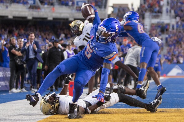 Boise State wide receiver Stefan Cobbs (5) scores a touchdown off of a pass from quarterback Maddux Madsen during the fourth quarter of an NCAA college football game against Central Florida, Saturday, Sept. 9, 2023, in Boise, Idaho. (Darin Oswald/Idaho Statesman via AP)