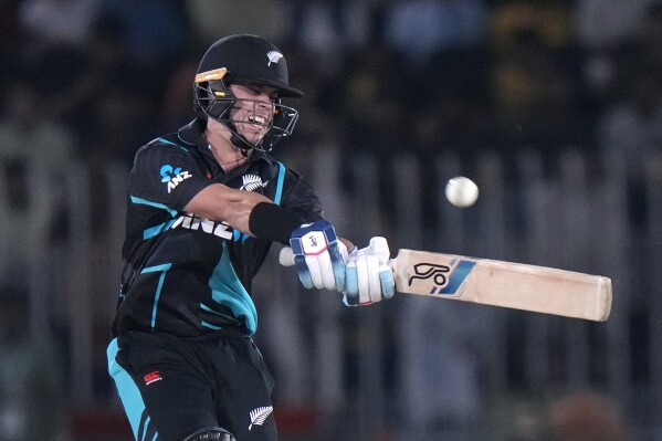 New Zealand's Mark Chapman plays a shot during the third T20 international cricket match between Pakistan and New Zealand, in Rawalpindi, Pakistan, Sunday, April 21, 2024. (AP Photo/Anjum Naveed)
