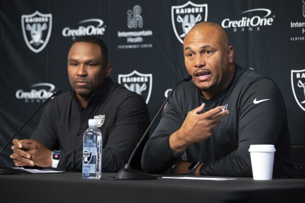 Las Vegas Raiders interim general manager Champ Kelly, left, and interim head coach Antonio Pierce speak with reporters during a news conference at the Raiders Headquarters/Intermountain Performance Center Wednesday, Nov. 1, 2023, in Henderson, Nev. (Steve Marcus/Las Vegas Sun via AP)