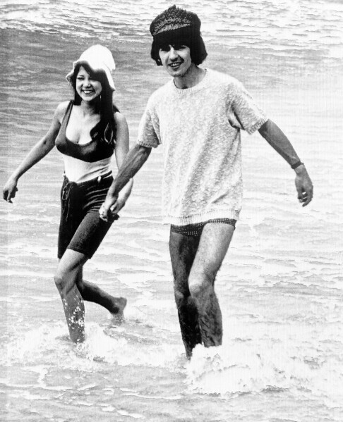 George Harrison, of the Beatles singing group, splashes in the surf with his bride, former model Pattie Boyd, February 12, 1966. Love letters to Pattie Boyd from both George Harrison and Eric Clapton are going up for sale at Christie’s auction house, alongside clothing, jewelry and other memorabilia from the renowned model and musicians’ muse. (AP Photo, File)