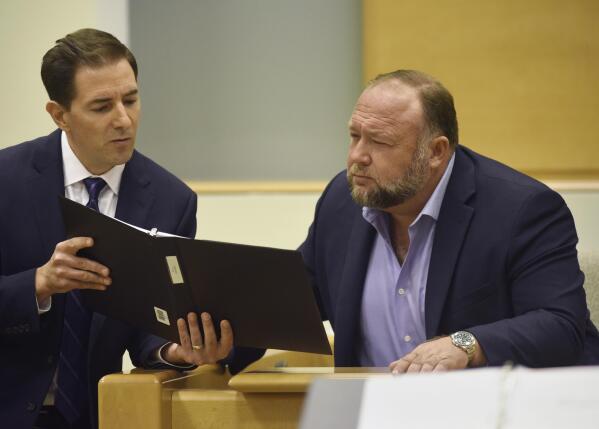 Plaintiff's attorney Chris Mattei, left, questions Conspiracy theorist Alex Jonesduring testimony at the Alex Jones Sandy Hook defamation damages trial at Connecticut Superior Court in Waterbury, Conn. Thursday, Sept. 22, 2022. Jones was found liable last year by default for damages to plaintiffs without a trial, as punishment for what the judge called his repeated failures to turn over documents to their lawyers. The six-member jury is now deciding how much Jones and Free Speech Systems, Infowars’ parent company, should pay the families for defaming them and intentionally inflicting emotional distress. (Tyler Sizemore/Hearst Connecticut Media via AP, Pool)