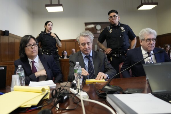 Defendants memorabilia seller Edward Kosinski, left, former Rock & Roll Hall of Fame curator Craig Inciardi, center, and rare-book dealer Glenn Horowitz take a seat at the defense table in Supreme Court, Thursday, Feb. 22, 2024, in New York. A judge in New York will continue hearing testimony today in a criminal case involving ownership of the handwritten lyrics for the songs on the 