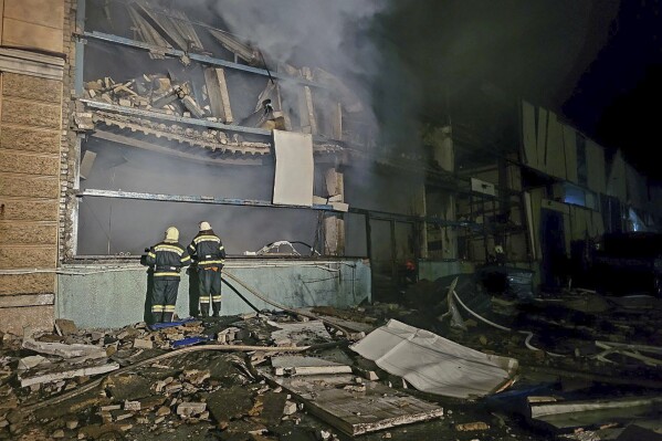 In this photo provided by the Odessa City Administration, Ukrainian emergency workers investigate the site of a Russian rocket attack in central Odessa, Ukraine, early Monday, Nov. 6, 2023.  (Odessa City Administration via AP)