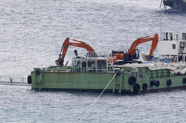 A reclamation work is resumed at a construction site off Henoko in Nago, Okinawa prefecture, southern Japan Wednesday, Jan. 10, 2024. Japan's central government on Wednesday forcibly resumed reclamation work at the planned relocation site of a disputed U.S. military base on the southern island of Okinawa despite persistent opposition and protests by residents and amid growing international criticisms that the move tramples on democracy and environment. (Kyodo News via AP)