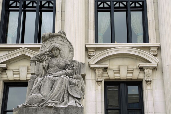 FILE - This Aug. 27, 2014 file photo shows a statue outside of the Illinois Supreme Court building in Springfield, Ill. The Illinois Supreme Court on Tuesday, July 18, 2023 upheld the constitutionality of a state law ending cash bail, ordering implementation in mid-September. The ruling overturns a Kankakee County judge’s opinion in December that the law violated the constitution’s provision that “all persons shall be bailable by sufficient sureties. (AP Photo/Seth Perlman, file)