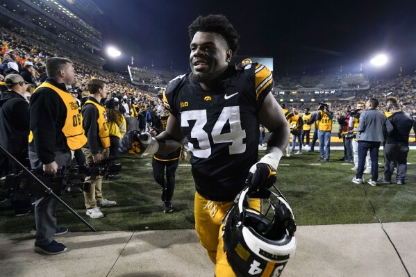 FILE - Iowa linebacker Jay Higgins (34) runs off the field after an NCAA college football game against Illinois, Saturday, Nov. 18, 2023, in Iowa City, Iowa. Iowa linebacker Jay Higgins will enter the Big Ten championship game against Michigan on Saturday with 141 tackles, most among players at Power Five conference schools. (AP Photo/Charlie Neibergall, File)