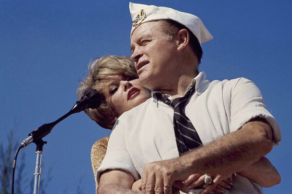 FILE - Bob Hope and Janis Paige hug during the annual Christmas show in Saigon, Vietnam, Dec. 25, 1964. Paige, a popular actor in Hollywood and in Broadway musicals and comedies who danced with Fred Astaire, toured with Bob Hope and continued to perform into her 80s, has died Sunday, June 2, 2024, of natural causes at her Los Angeles home, longtime friend Stuart Lampert said Monday, June 3. (AP Photo, File)