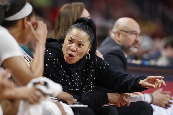 South Carolina head coach Dawn Staley talks to players on the bench during the second half of an NCAA college basketball game against Georgia in Columbia, S.C., Sunday, Feb. 26, 2023. South Carolina won 73-63. (AP Photo/Nell Redmond)