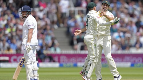 Australia captain Pat Cummins, right, celebrates with teammate Alex Carey after England's Jonny Bairstow was dismissed on the fifth day of the second Ashes Test match between England and Australia at Lord's Cricket Ground, London, Sunday, July 2, 2023.  (AP Photo/Kirsty Wigglesworth)