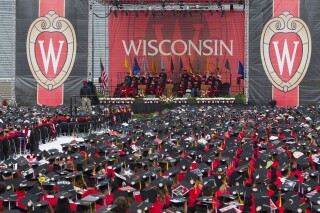 FILE - The commencement address is given during graduation at the University of Wisconsin in Madison, Wis., on May 12, 2018. The Universities of Wisconsin unveiled a $32 million workforce development plan Monday, Nov. 6, 2023 in an attempt to recover funds that were cut by the Republican-controlled Legislature earlier this year in a fight over campus diversity programs. (AP Photo/Jon Elswick, File)