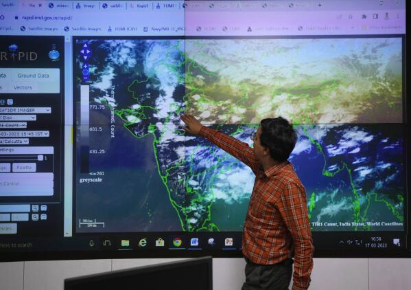 An employee at the India Meteorological Department watches a screen in New Delhi, India, Friday, March 17, 2023. The India Meteorological Department as well as the state of Kerala have increased infrastructure for cyclone warnings since Cyclone Ockhi in 2017, which killed about 245 fishermen out at sea. (AP Photo/Manish Swarup)
