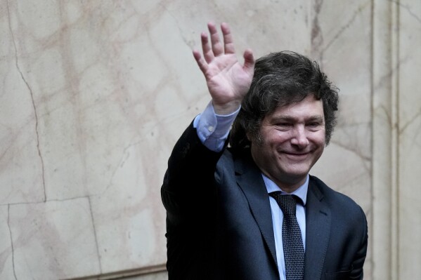 President-elect Javier Milei waves during a joint session of Congress to officially declare him and his running mate winners of the presidential runoff election, in Buenos Aires, Argentina, Wednesday, Nov. 29, 2023. (AP Photo/Natacha Pisarenko)