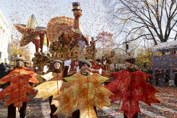 Parade performers lead the Tom Turkey float down Central Park West at the start of the Macy's Thanksgiving Day parade, Thursday, Nov. 23, 2023, in New York. (AP Photo/Jeenah Moon)