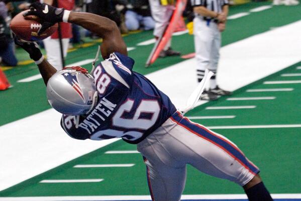 FILE - In this Feb. 3, 2002, file photo, New England Patriots wide receiver David Patten grabs a touchdown pass during the second quarter of Super Bowl XXXVI against the St. Louis Rams at the Louisiana Superdome in New Orleans, La. Patten, who caught Tom Brady's first postseason touchdown to help the Patriots win their first Super Bowl, was killed in a motorcycle accident on Thursday night, Sept. 3, 2021, outside of Columbia, S.C., Richard County coroner Naida Rutherford said in a statement. He was 47.  Patten played 12 seasons in the NFL after signing as an undrafted free agent with the New York Giants in 1997.  (AP Photo/Kathy Willens, File)