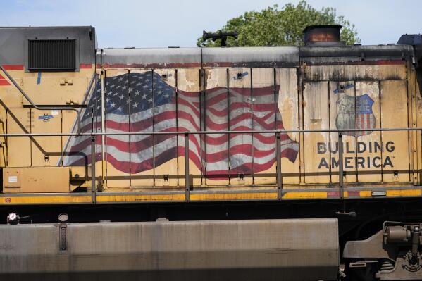 FILE - An American flag is emblazoned on this Union Pacific Railroad locomotive sitting in the Jackson, Miss., terminal rail yard, Wednesday, April 20, 2022.   Union Pacific's second-quarter profit improved a bit, but the railroad's expenses jumped as it tried to reduce the delivery delays that have left its customers waiting for trains at times. The railroad said Thursday, July 21,  that its profit grew 2% to $1.84 billion, or $2.93 per share.  (AP Photo/Rogelio V. Solis, File)