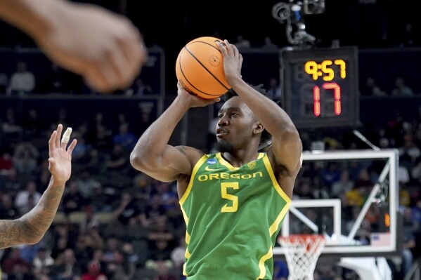 Oregon's Jermaine Couisnard (5) shoots during the second half of a first-round college basketball game against South Carolina in the NCAA Tournament in Pittsburgh, Thursday, March 21, 2024. (AP Photo/Gene J. Puskar)