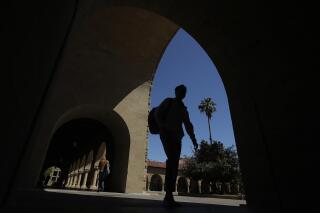 FILE - People walk on the campus at Stanford University in Stanford, Calif. A new federal report finds that record-keeping failures by the Education Department may have left thousands of Americans stuck with student debt that should have been forgiven. A study released Wednesday, April 20, 20220, by the Government Accountability Office revealed flaws in the management of income-driven repayment plans. (AP Photo/Jeff Chiu, File)