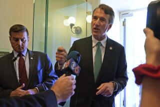 FILE - Virginia Gov. Glenn Youngkin, right, speaks to the media after leaving a meeting of the Senate Republican caucus at the Capitol Wednesday, April 27, 2022, in Richmond, Va. Fairfax County officials have rebuffed a request from Virginia Gov. Glenn Youngkin to establish a security perimeter around the neighborhoods of Supreme Court justices living in the county who have faced protests outside their homes. Youngkin, a Republican, made the request Wednesday, May 11, in a letter to the county board of supervisors. (AP Photo/Steve Helber, File)