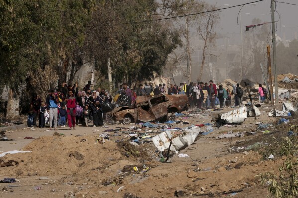 Palestinians flee to the southern Gaza Strip along Salah al-Din Street, on the outskirts of Gaza City, during the ongoing Israeli bombardment on Saturday, Nov. 18, 2023. (AP Photo/Adel Hana)