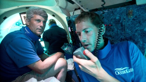 FILE - Submersible pilot Randy Holt, right, communicates with the support boat as he and Stockton Rush, left, CEO and Co-Founder of OceanGate, dive in the company's submersible, "Antipodes," about three miles off the coast of Fort Lauderdale, Fla., June 28, 2013. Rescuers in a remote area of the Atlantic Ocean raced against time Tuesday, June 20, 2023, to find a missing submersible before the oxygen supply runs out for five people, including Stockton, who were on a mission to document the wreckage of the Titanic. (AP Photo/Wilfredo Lee, File)