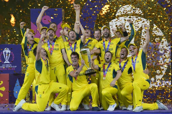 Australian players celebrate with the trophy after winning against India during the ICC Men's Cricket World Cup final match in Ahmedabad, India, Sunday, Nov.19, 2023. (AP Photo/Aijaz Rahi)