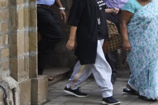 Bollywood actor Rhea Chakraborty walks out of the Narcotics Control Bureau (NCB) office to be taken for a medical check, in Mumbai, India, Tuesday, Sept. 8, 2020. The Bollywood actress who was arrested by India's narcotics agency, setting off a media frenzy that has gripped the nation, walked out of jail on Wednesday, Oct. 7, after being granted bail. Chakraborty was released from Bycula District Prison in Mumbai a month after being arrested for allegedly buying drugs for her boyfriend, popular movie actor Sushant Singh Rajput, who was found dead in a suspected suicide in June. (AP Photo/Bhushan Koyande)