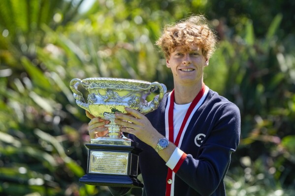 Jannik Sinner of Italy poses with the Norman Brookes Challenge Cup at a photo shoot the morning after defeating Daniil Medvedev of Russia in the men's singles final at the Australian Open tennis championships in Melbourne, Australia, Monday, Jan. 29, 2024. (AP Photo/Mark Baker)