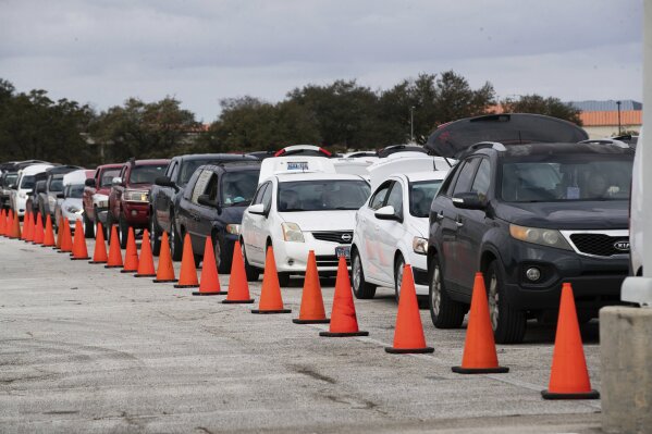 Hundreds of cars come through NRG Park to get food supplies during the Neighborhood Super Site food distribution event organized by the Houston Food Bank and HISD, Sunday, Feb. 21, 2021, in Houston. (Marie D. De Jesús/Houston Chronicle via AP)