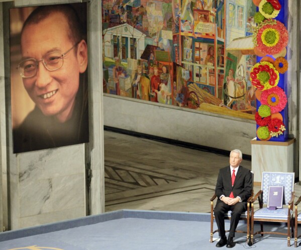 FILE - Nobel Commitee chairman Thorbjorn Jagland sits next to an empty chair with the Nobel Peace Prize medal and diploma during a ceremony honoring Nobel Peace Prize laureate Liu Xiaobo at city hall in Oslo, Norway, on Dec. 10, 2010. The head of the Norwegian Nobel Committee on Friday, Oct. 6, 2023 urged Iran to release imprisoned peace prize winner Narges Mohammadi and let her accept the award at the annual prize ceremony in December. Such appeals have had little effect in the past. Liu Xiaobo was serving an 11-year sentence for inciting subversion by advocating sweeping political reforms and greater human rights in China when the Norwegian Nobel Committee selected him for the peace prize in 2010. (AP Photo/John McConnico, File)