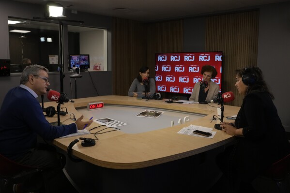 Sandrine Sebbane, programme director and journalist at RCJ, the the Radio of the Jewish Community, right, Marie-Claude Egry, clinical psychologist, second right, Stephanie Kastel, psychotherapist specialized in trauma related disorders, third right, and Philippe Levy, director of the youth action programme at the FSJU, (United Jewish Social Fund) federating Jewish associations in France, speak, at RCJ radio, in Paris, Wednesday, Oct. 18, 2023. French Jewish groups have set up a helpline for people in the community traumatized by Israel-Hamas war. Organizers say dozens are calling in every day since shortly after the Oct. 7 Hamas rampage in southern Israel. (AP Photo/Thibault Camus)