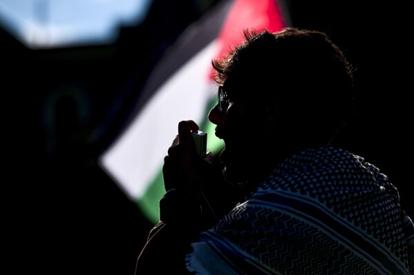 West Virginia University Muslim Student Association President Omar Ibraheem leads a chant during a pro-Palestinian protest at Woodburn Hall in Morgantown, W.Va., Saturday, May 11, 2024. (William Wotring/The Dominion-Post via AP)