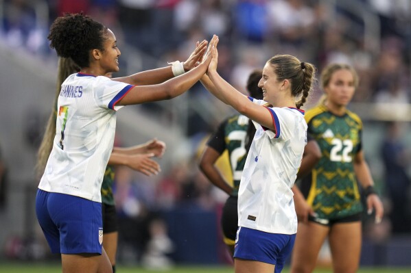 United States' Ally Sentnor, right, is congratulated by teammate Lily Yohannes after scoring during the first half of an international friendly soccer match against Jamaica Tuesday, June 3, 2025, in St. Louis. (AP Photo/Jeff Roberson)