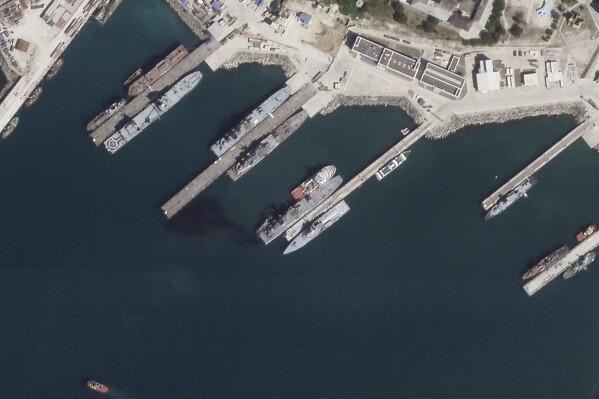 This satellite photo from Planet Labs PBC appears to show the damaged Russian landing vessel Olenegorsky Gornyak leaking oil while docked at Novorossiysk, Russia, Friday, Aug. 4, 2023. Ukraine said its sea drones struck a major Russian port Friday and damaged the warship in an attack that underlined Kyiv's growing capabilities as the Black Sea becomes an increasingly important battleground in the war. (Planet Labs PBC via AP)