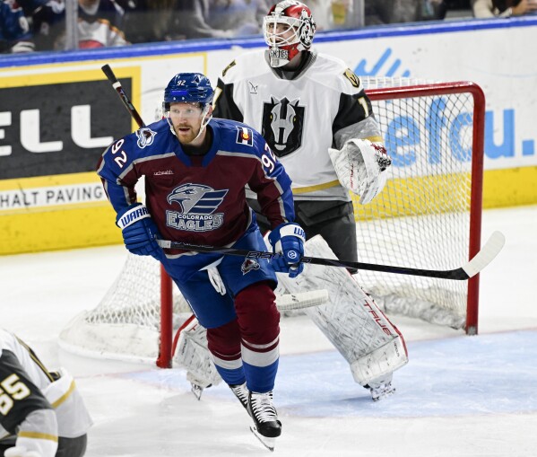 Colorado Eagles forward Gabriel Landeskog, front, skates past Henderson Silver Knights goalie Cameron Whitehead in the third period of a minor league hockey game Friday, April 11, 2025, in Loveland, Colo. (Andy Cross/The Denver Post via AP)