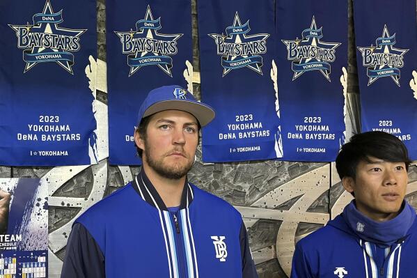 Trevor Bauer, left, listens to a reporter's question after a warm-up game in Hiratsuka, southwest of Tokyo, Japan, Saturday, April 22, 2023. Bauer on Saturday pitched his second game against minor-league competition as he prepares for his debut with the Yokohama DeNA BayStars. (AP Photo/Stephen Wade)