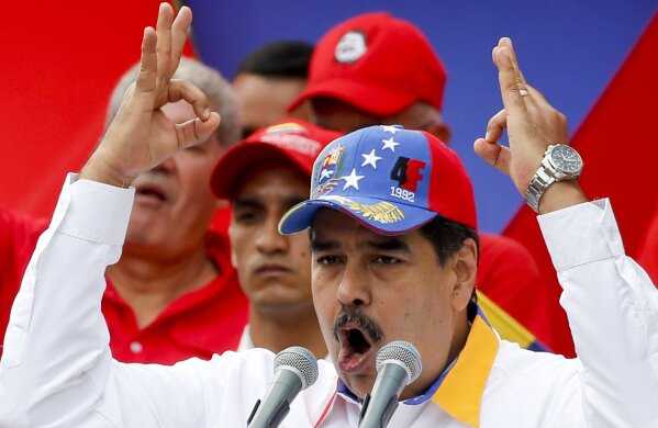 
              Venezuela's President Nicolas Maduro speaks during an anti-imperialist rally for peace, in Caracas, Venezuela, Saturday, March 23, 2019. The U.S. withdrew all embassy personnel from Caracas due to safety concerns after Maduro severed ties with the U.S. over its support for opposition leader Juan Guaido. (AP Photo/Natacha Pisarenko)
            