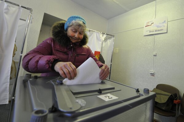 
              A woman casts her ballot at a polling station in Yelisovo, about 30 kilometers ( 19 miles) north-east from Petropavlovsk-Kamchatsky, capital of Kamchatka Peninsula region, Russian Far East, Russia, on Sunday, March. 18, 2018. Polls have opened in Russia's Far East for the presidential election in which Vladimir Putin seeks a 4th term. (AP Photo/Alexander Petpov)
            